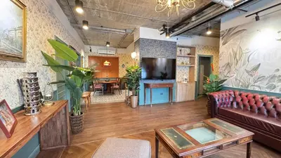 a living room with a couch and a table at Nara Poshtel Sathorn in Bangkok