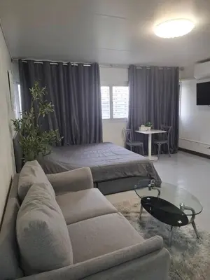 a living room with a couch and a bed at Popular Muang Thong Condo, Building T9, Floor 8, Room 20 in Ban Bang Phang