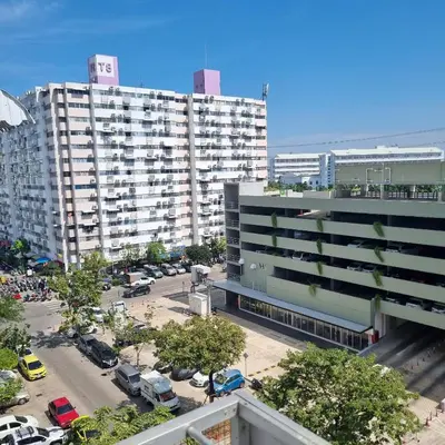 a large building with cars parked in a parking lot at Popular Muang Thong Condo, Building T9, Floor 8, Room 20 in Ban Bang Phang