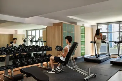 a man and a woman in a gym at Courtyard by Marriott Bangkok Sukhumvit 20 in Bangkok