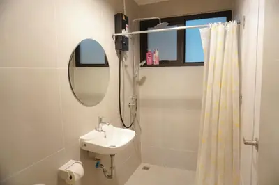 a bathroom with a sink and a shower and a mirror at Buddy House in Chinatown - Private Rooms Walk to MRT in Bangkok