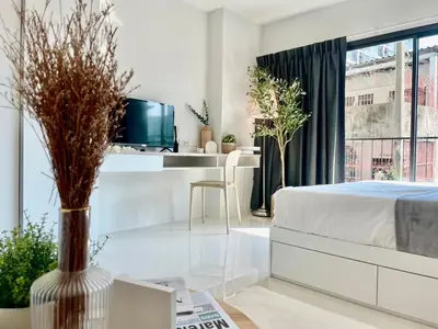 a bedroom with a bed and a desk with a tv at Cozy stay! Near Chatuchak Market 814 in Bangkok