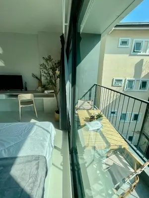a room with a balcony with a bed and a table at Cozy stay! Near Chatuchak Market 814 in Bangkok