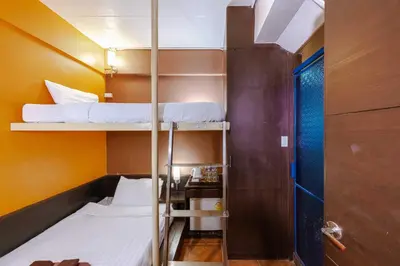 a small room with two bunk beds in it at Diamond House Khaosan in Bangkok