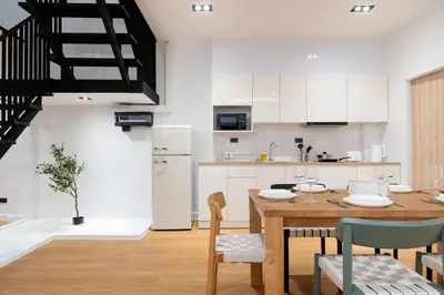 a kitchen and dining room with a table and chairs at Townhouse in Khet Phayathai - Ari in Bangkok