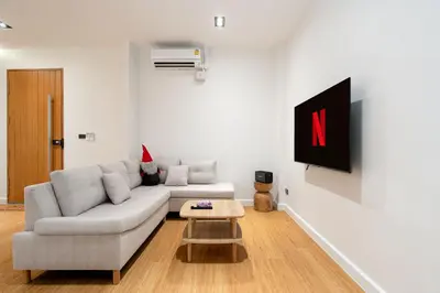 a living room with a couch and a tv at Townhouse in Khet Phayathai - Ari in Bangkok