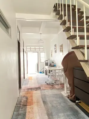 a hallway with a spiral staircase in a house at Cheap house 7min next to BTS Kasetsart , 5 bedroom in Ban Yang