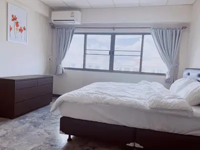 a bedroom with a large bed and a window at 55sqm Hispeed LAN WiFi workplace 24h maxvalu in Bangkok