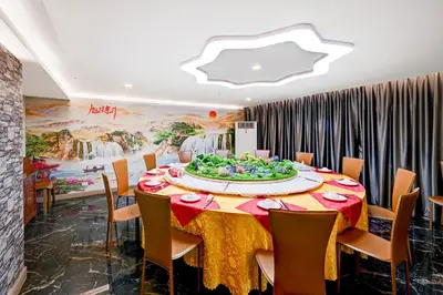 a dining room with a table with a cake on it at Dancenter Bangkok Travellers Hotel in Bangkok