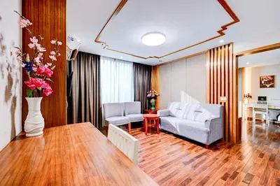a living room with a couch and a table at Dancenter Bangkok Travellers Hotel in Bangkok