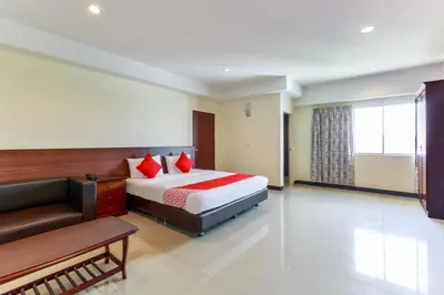 a hotel room with a bed and a couch at Dancenter VResotel in Bangkok