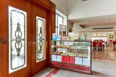 a bakery with a display case of pastries at Dancenter VResotel in Bangkok