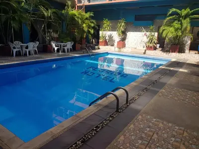 a pool at a hotel with blue water at Florida Hotel in Bangkok