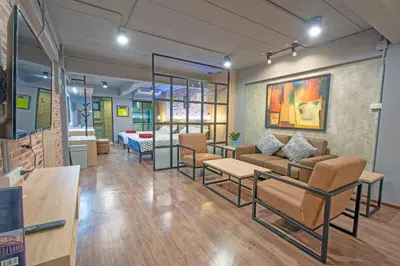 a living room with a couch and a table at Private apartment in Huaikwang in Bangkok
