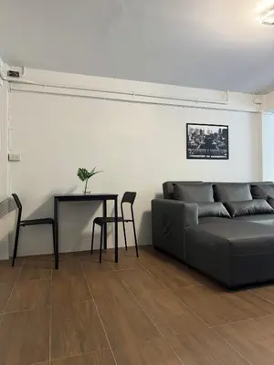a living room with a couch and a table at Berlin Haus in Nonthaburi