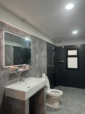 a bathroom with a sink and a toilet at Berlin Haus in Nonthaburi