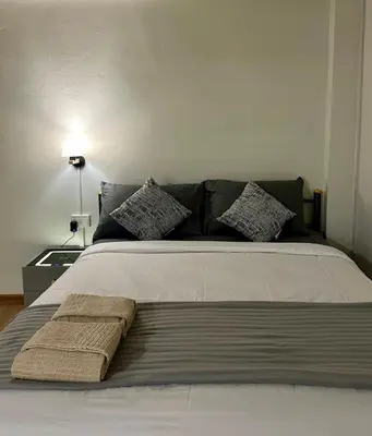 a bed with two towels on it in a bedroom at Sukkasame Apartment At Ngamwongwan in Ban Bang Khen (1)