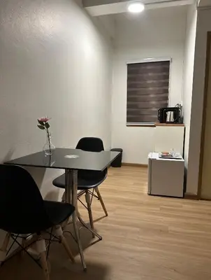 a dining room with a table and some chairs at Sukkasame Apartment At Ngamwongwan in Ban Bang Khen (1)