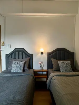 two beds sitting next to each other in a room at Sukkasame Apartment At Ngamwongwan in Ban Bang Khen (1)
