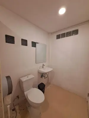 a bathroom with a toilet and a sink at The Yellow House Poolvilla in Sathani Ban Hua Mak
