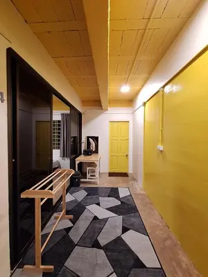 a hallway with a bench and a yellow door at The Yellow House Poolvilla in Sathani Ban Hua Mak
