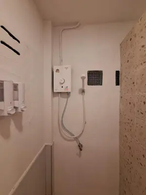 a bathroom with a shower in the wall at The Yellow House Poolvilla in Sathani Ban Hua Mak