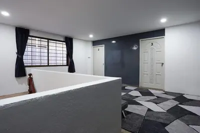 a large room with a counter and a door at Number 8 Poolvilla Bangkok in Sathani Ban Hua Mak