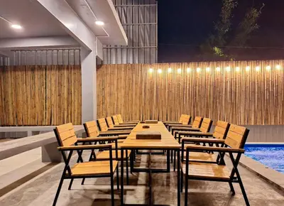 a conference room with a table and chairs and a pool at Number 8 Poolvilla Bangkok in Sathani Ban Hua Mak