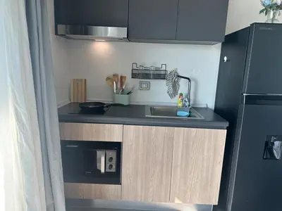 a small kitchen with a sink and a refrigerator at Chill Condo near Icon Siam in Bangkok