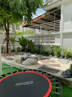 a trampoline in the middle of a garden at Cheap house 7min next to BTS Kasetsart , 5 bedroom in Ban Yang