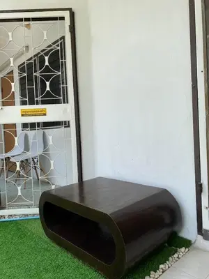 a bench sitting next to a door with a window at Cheap house 7min next to BTS Kasetsart , 5 bedroom in Ban Yang