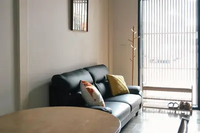 a living room with a couch and a table at SuXiang - Chinatown, Bangkok in Bangkok
