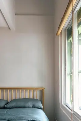 a bedroom with a bed and a window at SuXiang - Chinatown, Bangkok in Bangkok