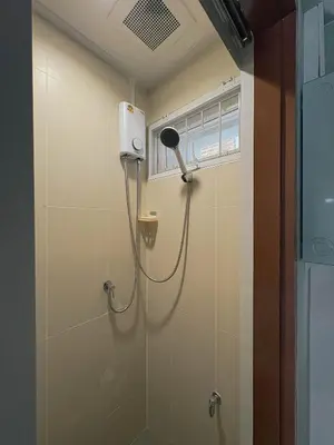 a shower in a bathroom with a blow dryer at SuXiang - Chinatown, Bangkok in Bangkok