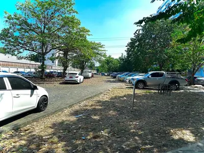 a bunch of cars parked in a parking lot at CinCin Popular Condo in Thung Si Kan
