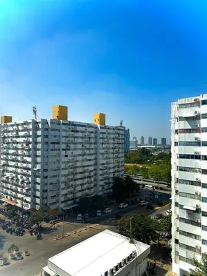 an aerial view of a large building with a parking lot at CinCin Popular Condo in Thung Si Kan
