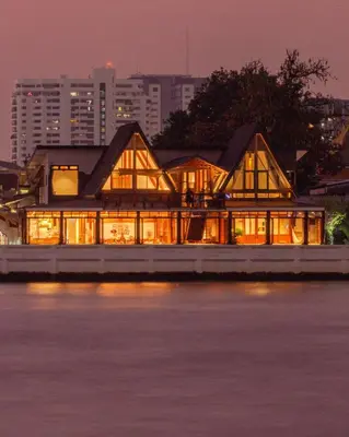a house on the water at night at Baan Manee BKK in Bangkok