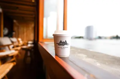 a cup of coffee sitting on a window sill at Baan Manee BKK in Bangkok