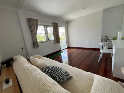 a living room with a white couch and wooden floors at 5 beds private garden resort 452sqm Pet relax in Sathani Ban Hua Mak