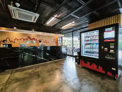 a restaurant with a bar with a drink machine at Galleria 12 Sukhumvit Bangkok by Compass Hospitality in Bangkok