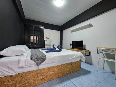 a bedroom with a bed with a blue towel on it at Irich Residence Theparak S209 BTS-Chang Erawan 2kms in Ban Khlong Hua Sakae
