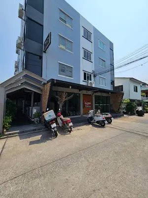 a group of motorcycles parked in front of a building at Irich Residence Theparak S209 BTS-Chang Erawan 2kms in Ban Khlong Hua Sakae