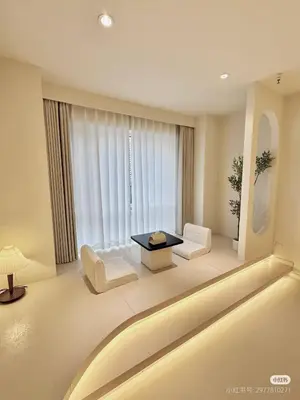 a living room with a table and chairs in front of a window at Happy house in Bangkok