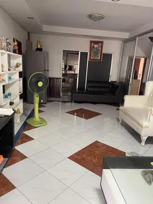 a living room with a white tiled floor at Home Rama 4 near BTS Thong Lor in Khlong Toei
