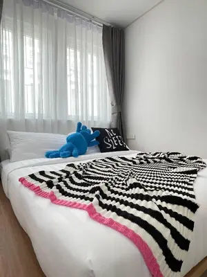 a blue teddy bear laying on top of a bed at Nueng Rana 113 Unique House in Chinatown 3BR 2BA - Villa in Samphanthawong