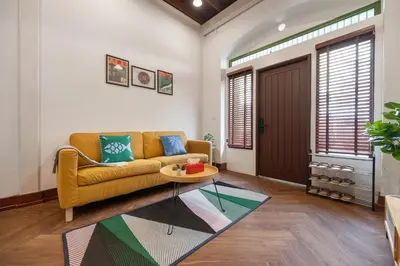 a living room with a couch and a table at Moondance House Chinatown in Bangkok