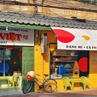 a bike parked in front of a store at Best River view, Retro vibe studio apartment - Bangkok Old Town in Bangkok