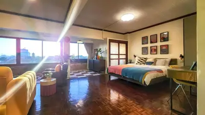 a bedroom with a bed and a desk in it at Best River view, Retro vibe studio apartment - Bangkok Old Town in Bangkok