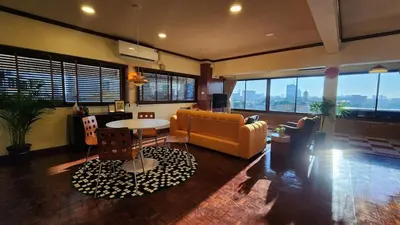 a living room with a couch and a table at Best River view, Retro vibe studio apartment - Bangkok Old Town in Bangkok