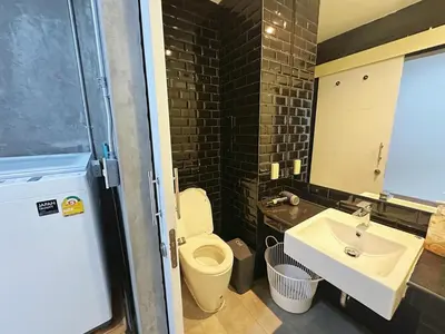 a bathroom with a toilet and a sink at 260m walk to BTS Prakanong in Bangkok